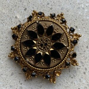 Elegant Gold and Black Brooch
